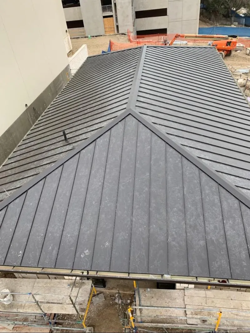 Commercial metal roof construction with crane equipment in McKeesport